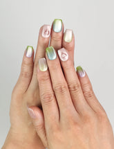 Model wearing Gradient Heart handmade press on nails with pastel gradient and glossy finish, coquette nails look